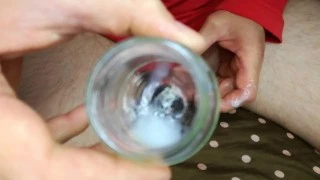 The farmer in the bedroom masturbates and collects semen in glass