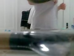 My girlfriend plays with her pubic hair on a bathroom cam