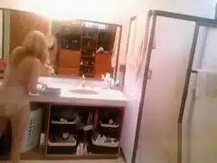 Busty blonde brushes her hair and takes a shower
