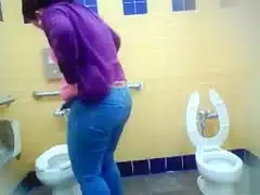 Mature Mexican woman goes pee in a public bathroom
