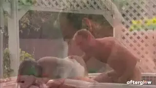 A real couple has romantic sex in a hot tub