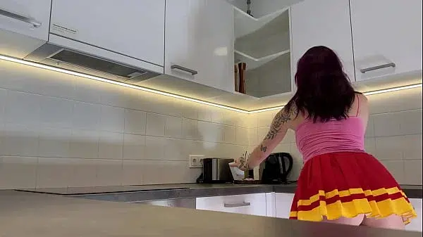 Hottest redhead tattooed cheerleader with over knee socks shows her see through panties in the kitchen