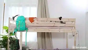 Big-Titted Brunette Guides Her Roommate’s Mouth Down Her Body on the Hostel Bed